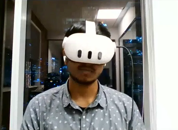 An engineer wearing a mixed-reality headset during a video call