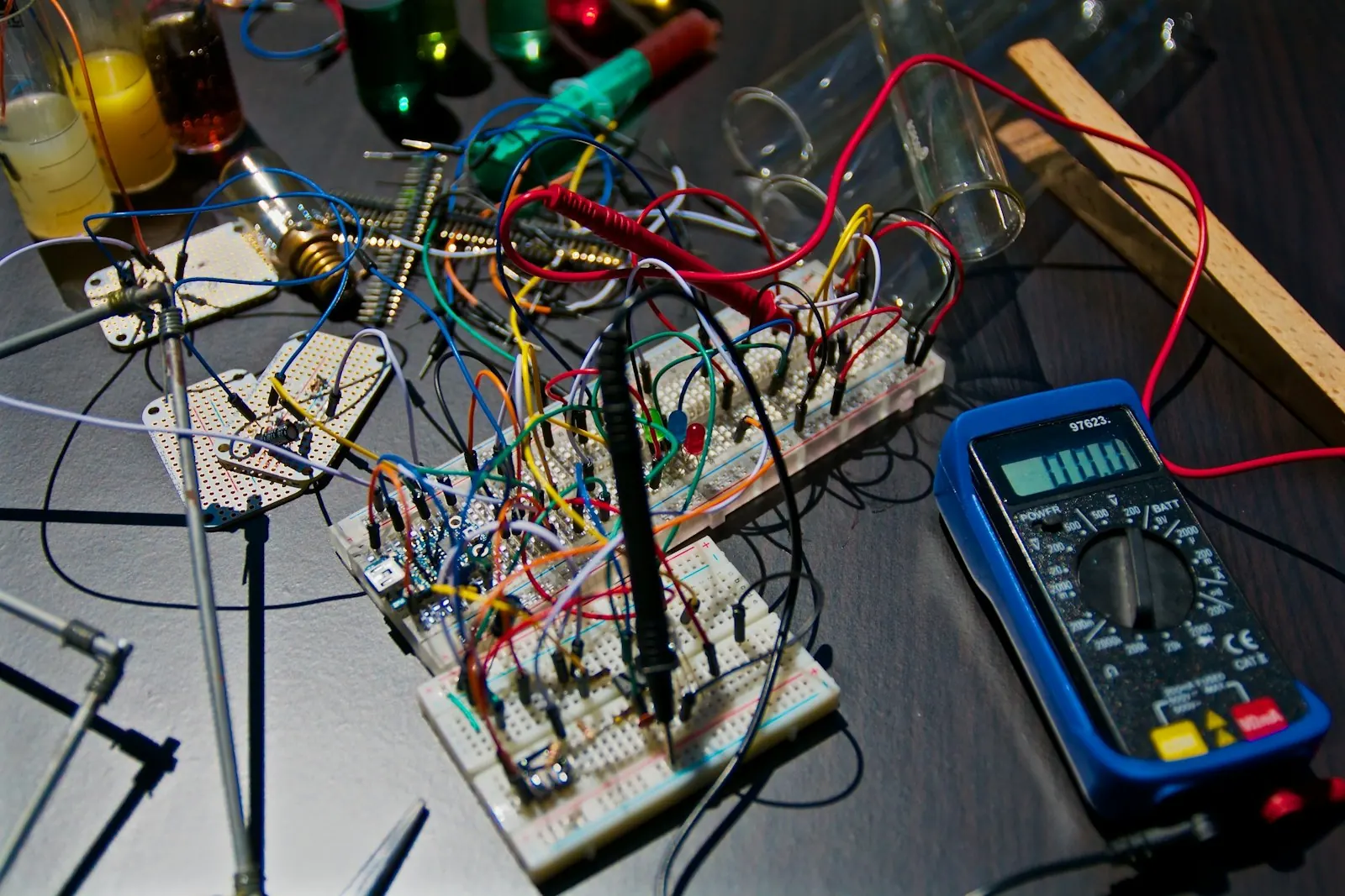 A prototyping bench of wiring, breadboards and a multimeter